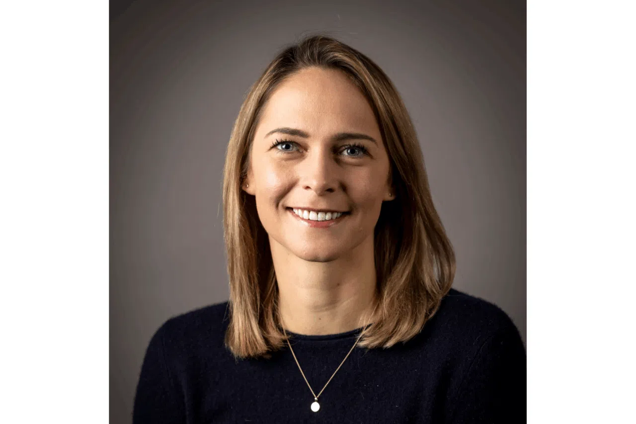 Portrait of Maike Frölich, Country Manager Germany at Visual Art, smiling in a dark top against a neutral background.